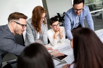 Group of lawyers discussing contract together in office