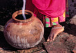 © Ric Ergenbright/Danita Delimont - Asia, India, Rajasthan. A woman in a pretty sari pauses at the well to fill her clay pot in Rajasthan, India.