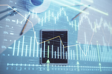 Double exposure of forex graph on digital tablet laying on table background. Concept of market analysis