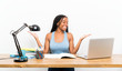 © luismolinero - African American teenager student girl with long braided hair in her workplace holding copyspace with two hands