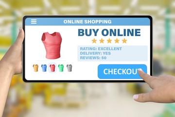 hand with tablet computer tapping the button checkout on bokeh mall background - online shopping technology concept