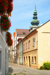 Wall Mural - Wels, Upper Austria, Austria - A narrow lane is passing between multi-story buildings in a residential part of town.