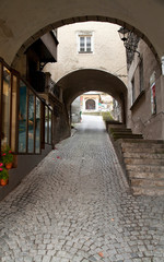 Poster - Salzburg, Salzburg, Austria - Low angle view from the bottom of an arched walkway. It is partially enclosed on the sides and at the top.