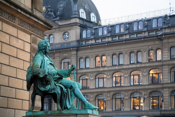 Sticker - Copenhagen, Denmark - A statue of a man sitting in a chair wearing 18th century clothes is outside a building.