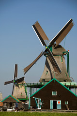 Poster - The Netherlands (aka Holland), Zaandam. Zaanse Schans, historic open air museum of life in the 17th century. Historic windmills with tourists.