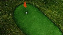 Close-up Of Golfer Using Putter To Sink Short Putt Into Hole