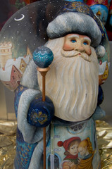 Canvas Print - Russia, Moscow, Red Square. Traditional Russian wood carved Santa.