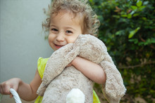 Cute Little Girl Hugging Her Stuffed Easter Bunny Plush Toy
