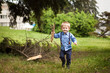 © justesfir - Little boy play with wooden branches and smile outdoors in summer