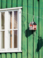 Poster - Birdfeeder on colorful house. Small town of Uummannaq, northwest Greenland.