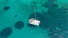 Aerial Drone Birds Eye View Of Sail Boat Cruising In The Deep Blue Aegean Sea, Greece