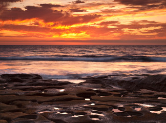 Wall Mural - USA, California, La Jolla. Sunset over tide pools at Coast Blvd. Park