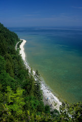 Michigan: Mackinac Island, Mackinac Island State Park, Lake Huron, view N. from Arch Rock of coastline and two bicyclists.