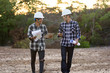 © SVRSLYIMAGES - portrait of two engineer's or architect's with hardhat walking across the field