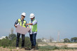 © SVRSLYIMAGES - portrait of two engineer's or architect's dress with hardhat, safety helmet and safety vest have a meeting outdoors