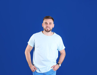 Poster - Portrait of handsome happy man on color background