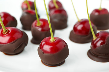 Poster - Chocolate dipped cherries on white background, closeup