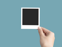 Hand Holding Mock Up Blank Photo Frame Isolated On Blue Background With Clipping Path