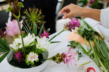 Wall Mural - florist arranging flower bouquet in vase. floristry class course workshop