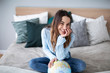 © BestForYou - Portrait of a beautiful happy woman with a globe indoors.
