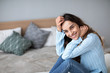 © BestForYou - Gorgeous young smiling woman is sitting on the couch and looks on camera.
