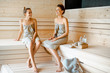 Two girlfriends relaxing in the sauna