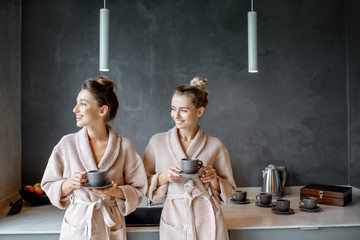 Wall Mural - Women in bathrobes relaxing on the kitchen