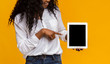 © Prostock-studio - Black lady pointing at blank digital tablet screen