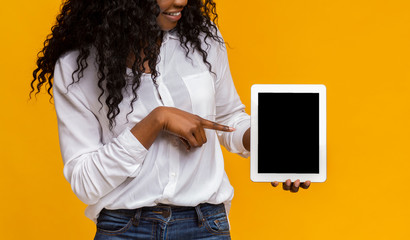 Black lady pointing at blank digital tablet screen