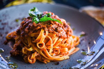 Wall Mural - delicious italian spaghetti bolognese with minced beef sauce, tomatoes, carrots & fresh basil 