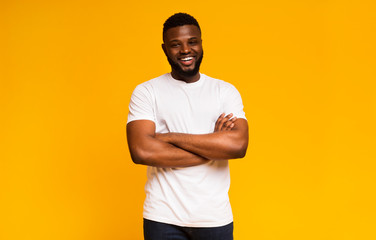 Muscular young african man standing with his arms crossed