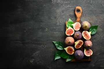 Figs on wooden background. Tropical fruits. Top view. Free copy space.