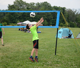 Wall Mural - Boy setting the ball on outdoor grass game