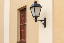 Black Wrought Streetlamp On Light Wall