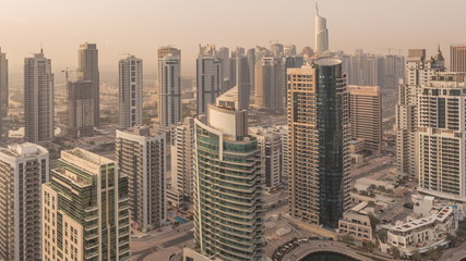  Aerial top view of Dubai Marina morning timelapse. Modern towers and traffic on the road