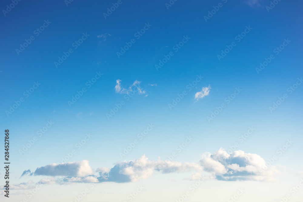 beautiful cloudscape in evening light. fluffy clouds on the blue sky - obrazy, fototapety, plakaty 