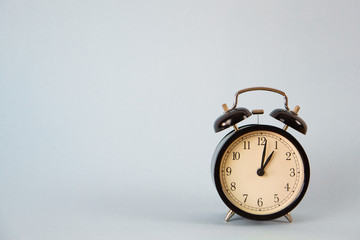 old alarm clock on a grey blue background