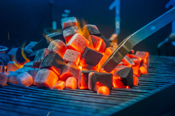 Coals for hookah. Hookah Smoking. Warming up the coals on a special grill. Hookah bar for Smoking people. Inverting the coals for even heating.