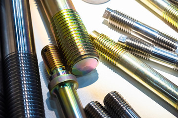 Metal products with thread. Threaded studs of different sizes. Metalworking. Products for fasteners. Industrial concept. Threads on metal workpieces