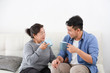 © chayathon2000 - Asian senior grand mother and son drinking coffee and talking happy and smile face in living room