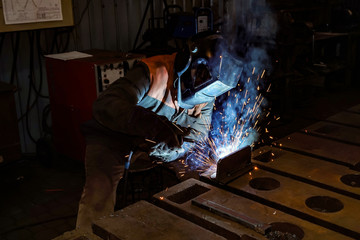 Welder at work in a workshop for the manufacture of metal structures.