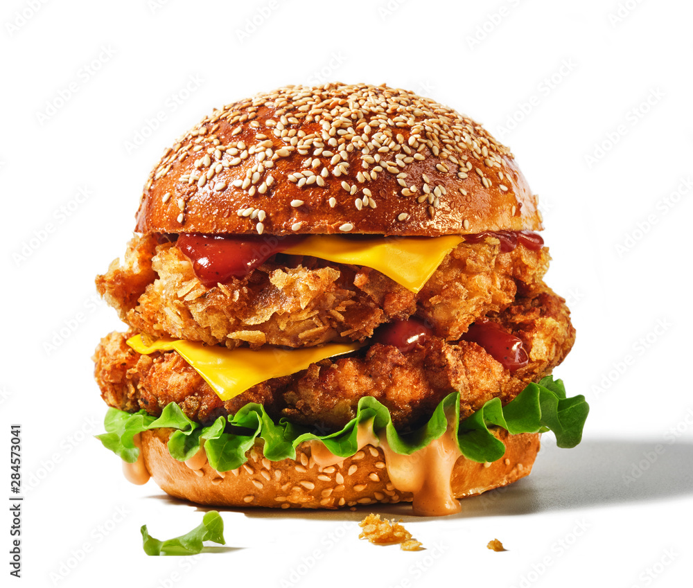 Fresh tasty burger isolated on white background. Big double cheddar cheeseburger with chicken cutlet. - obrazy, fototapety, plakaty 