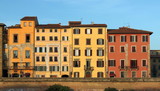 Fototapeta Miasto - Historical apartment house facades in Pisa, Italy, at sunset