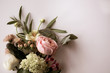 canvas print picture - Horizontal image of fresh cut, pastel flowers and greenery on a white background with copy space