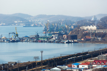 Coal terminal in the sea trading port of the sea city of Nakhodka. Coal collapse on the coast of a large city.