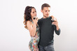 © satura_ - Man and woman are holding glasses of dark beer on white background. Oktoberfest concept.