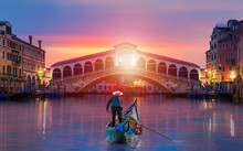 Gondolier Carries Tourists On Gondola Near Rialto Bridge - Venice, Italy