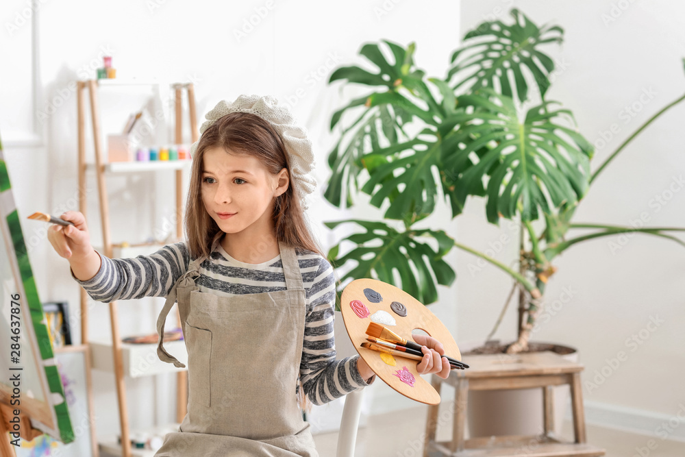 Cute little artist in studio