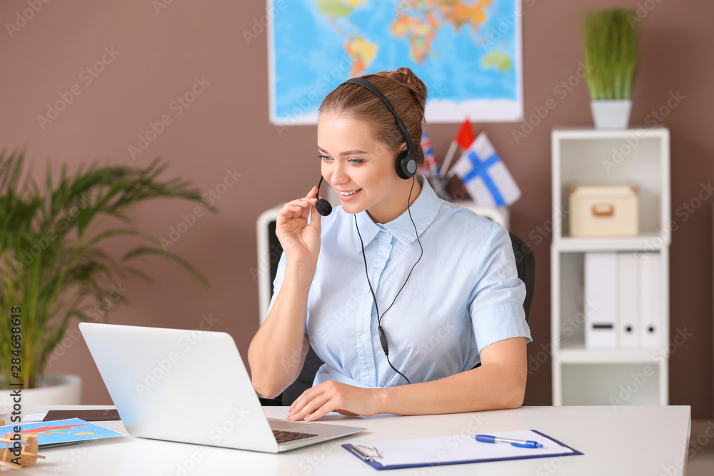 Female travel agent working in office