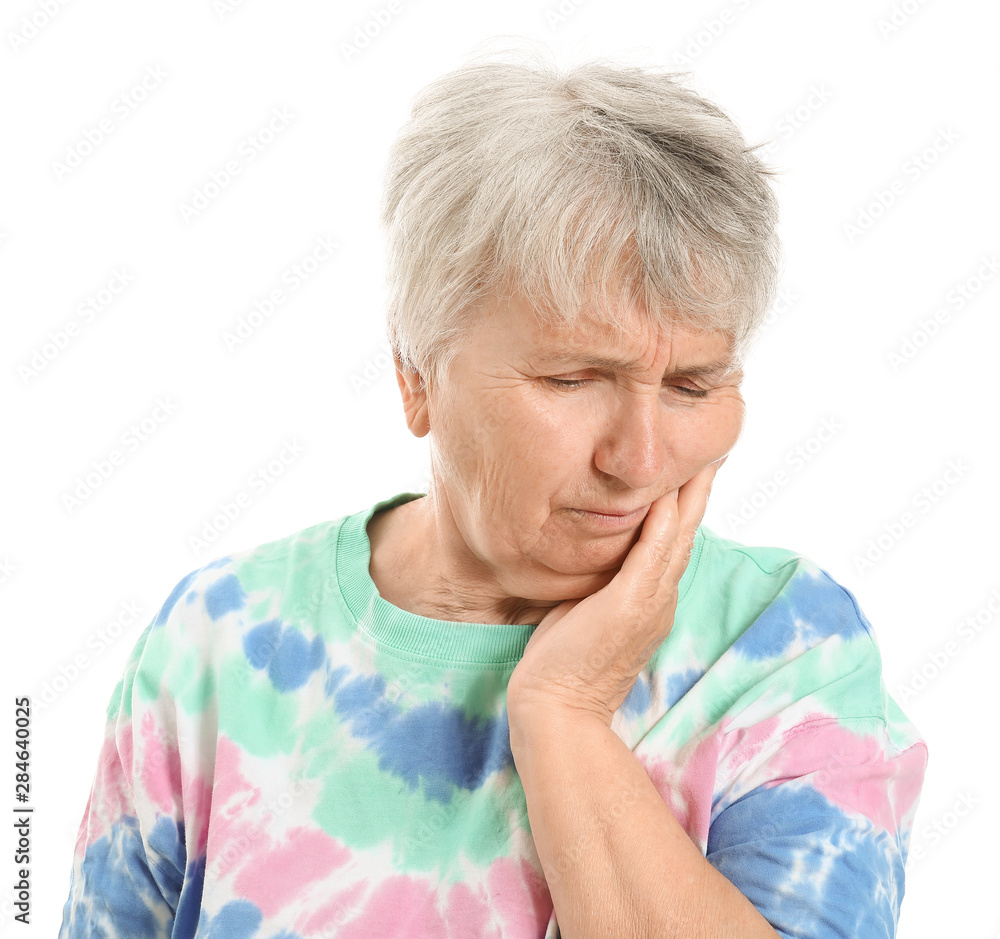 Senior woman suffering from toothache against white background